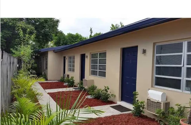a view of an house with backyard space and garden