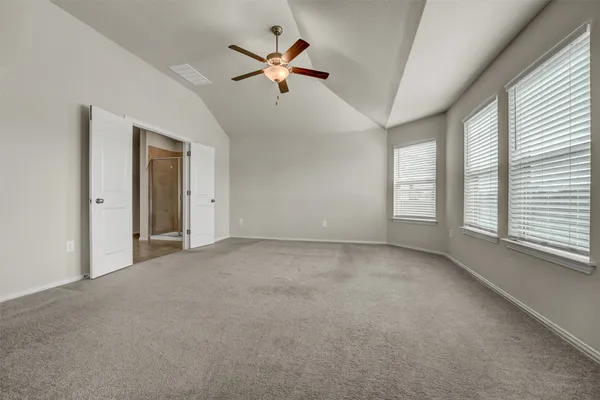 a view of a livingroom with a ceiling fan and window