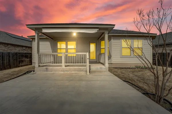 a view of a house with a door and wooden fence