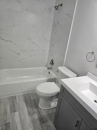 a bathroom with a sink a toilet and a bathtub