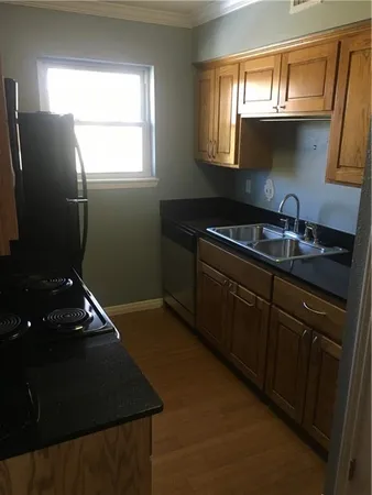 a kitchen with granite countertop a refrigerator and a sink