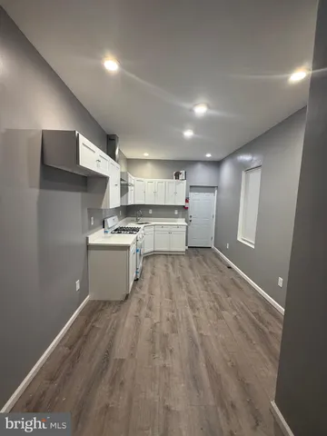 a kitchen with a refrigerator and a sink