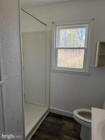 a bathroom with a toilet and a shower