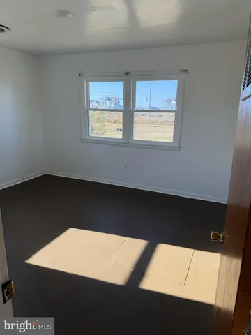a view of an empty room with windows