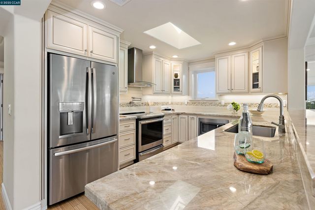 a bathroom with a granite countertop sink a toilet and shower