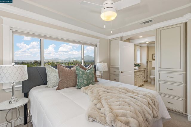 a bathroom with a granite countertop sink a toilet and a mirror