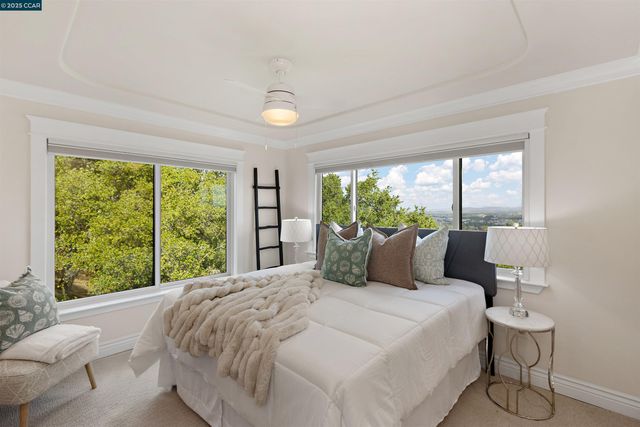 a en suite bathroom with a granite countertop sink and a large mirror