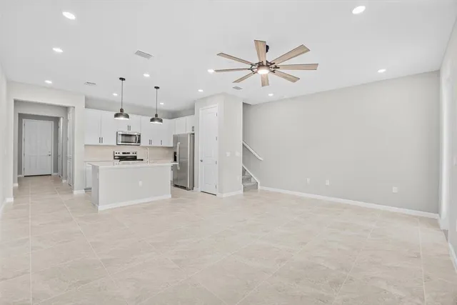 a view of a kitchen with a sink and a refrigerator