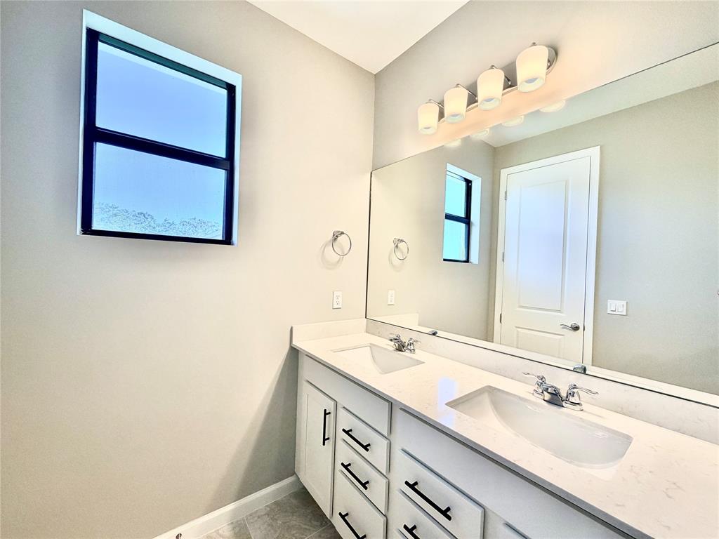 288 Southwest Sally Way Stuart, FL 34997 - Photo 16 of 22 a bathroom with a double vanity sink and a mirror