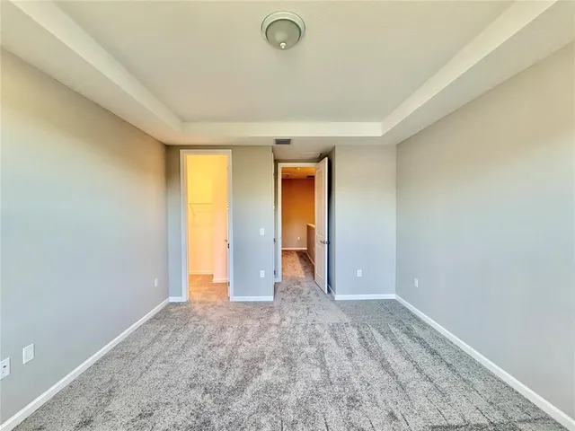 an empty room with closet and wooden floor