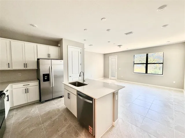 a kitchen with a stove a refrigerator and a sink