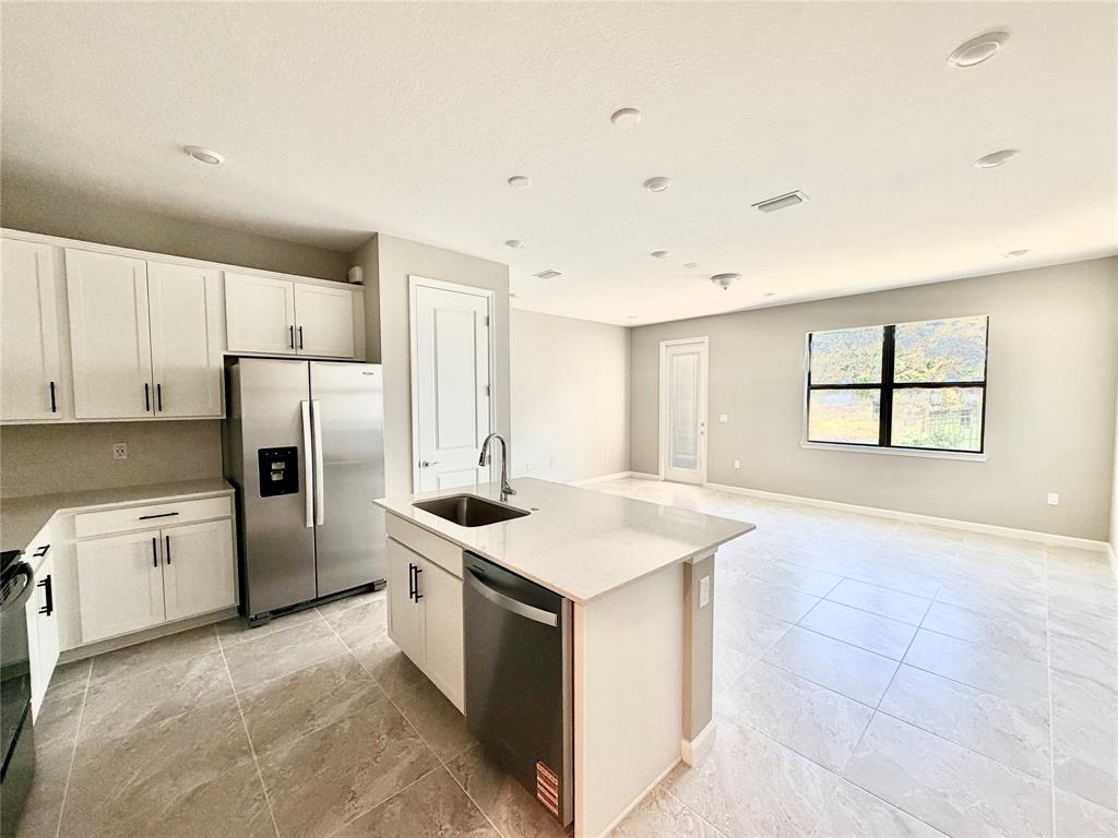 288 Southwest Sally Way Stuart, FL 34997 - Photo 2 of 22 a kitchen with a stove a refrigerator and a sink