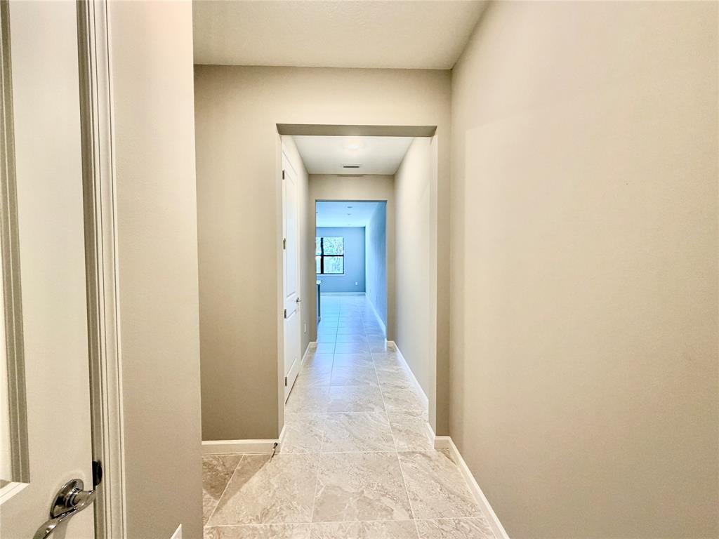 288 Southwest Sally Way Stuart, FL 34997 - Photo 4 of 22 a view of a hallway with wooden floor