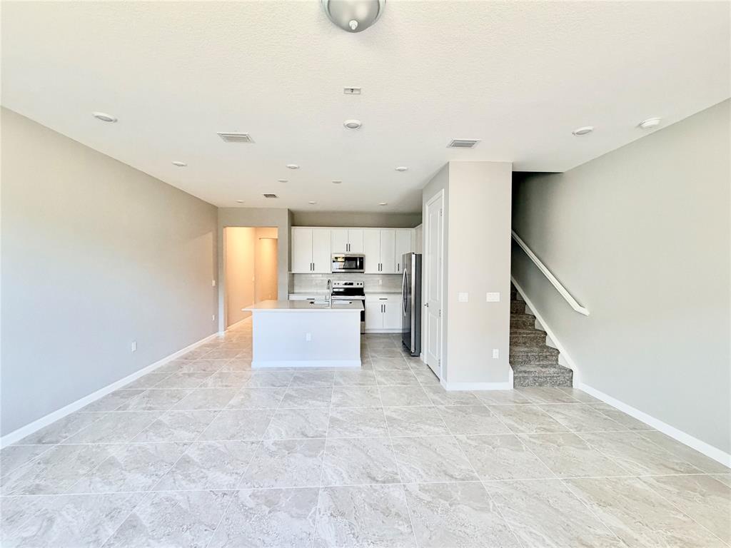 288 Southwest Sally Way Stuart, FL 34997 - Photo 5 of 22 a view of a kitchen with furniture and staircase