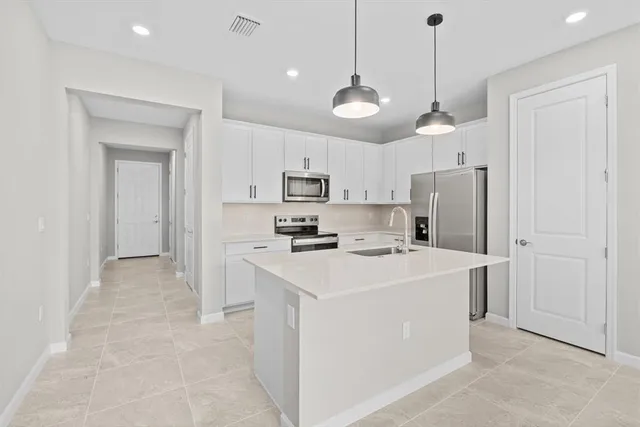 a view of a kitchen sink and refrigerator