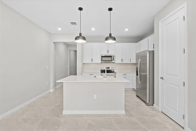 a view of a kitchen and stainless steel appliances