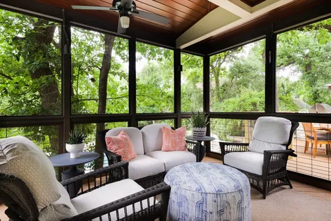 a living room with furniture and a floor to ceiling window