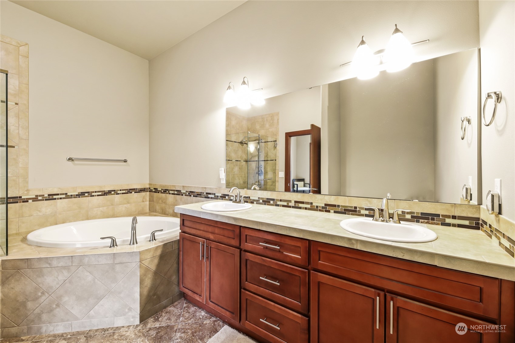 4005 Northeast 3rd Place, Unit 3E Renton, WA 98056 - Photo 13 of 28 a bathroom with a tub a double vanity sink and mirror