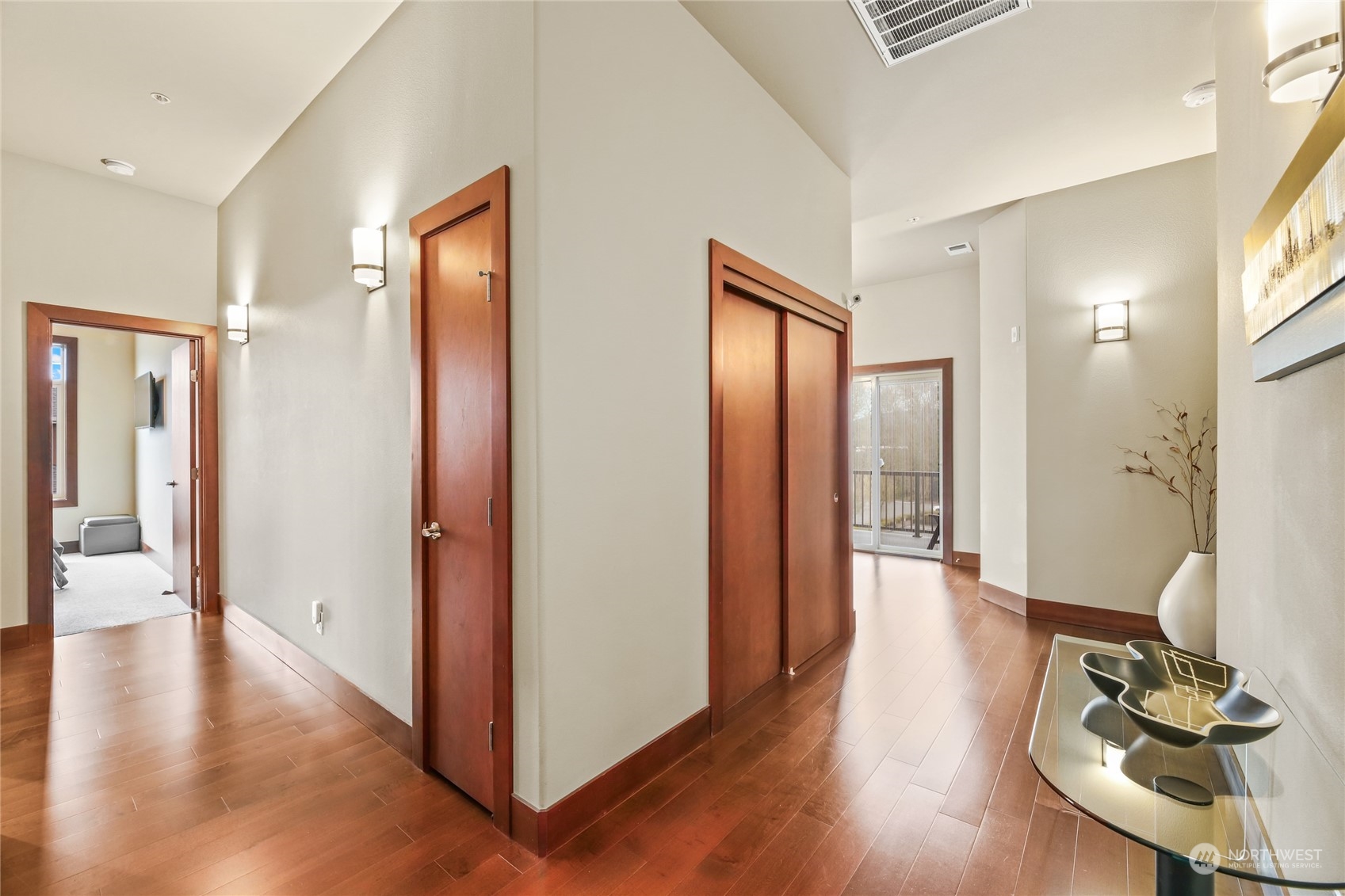4005 Northeast 3rd Place, Unit 3E Renton, WA 98056 - Photo 15 of 28 a view of a hallway with wooden floor and furniture
