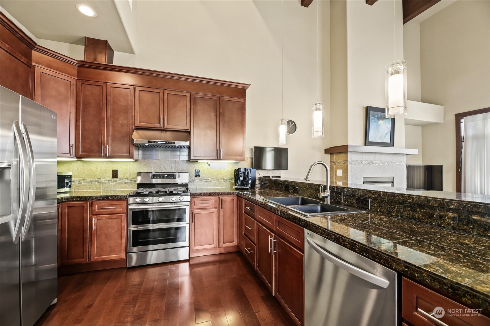 4005 Northeast 3rd Place, Unit 3E Renton, WA 98056 - Photo 10 of 28 a kitchen with stainless steel appliances granite countertop a sink stove and refrigerator