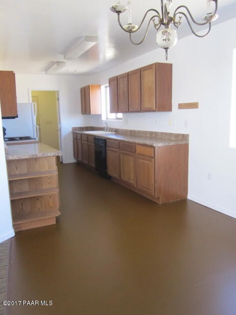 665 West Ahonen Road Paulden, AZ 86334 - Photo 6 of 18 a kitchen with cabinets and window