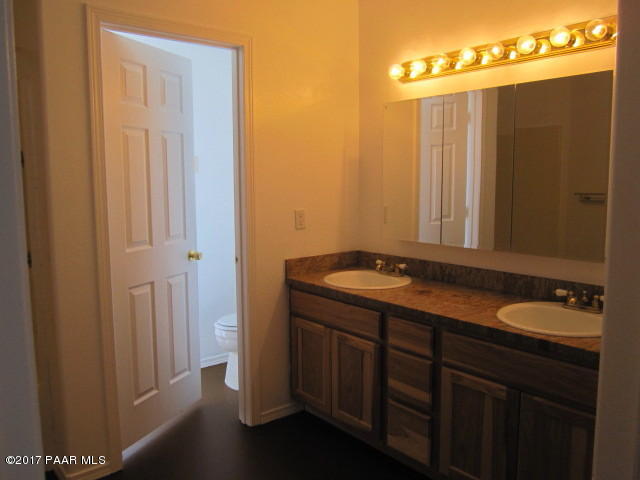 665 West Ahonen Road Paulden, AZ 86334 - Photo 9 of 18 a bathroom with a granite countertop sink and a mirror