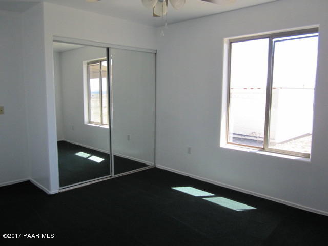 665 West Ahonen Road Paulden, AZ 86334 - Photo 10 of 18 a view of an empty room with wooden floor and a window