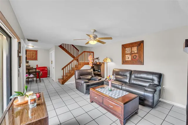 a living room with furniture and a potted plant