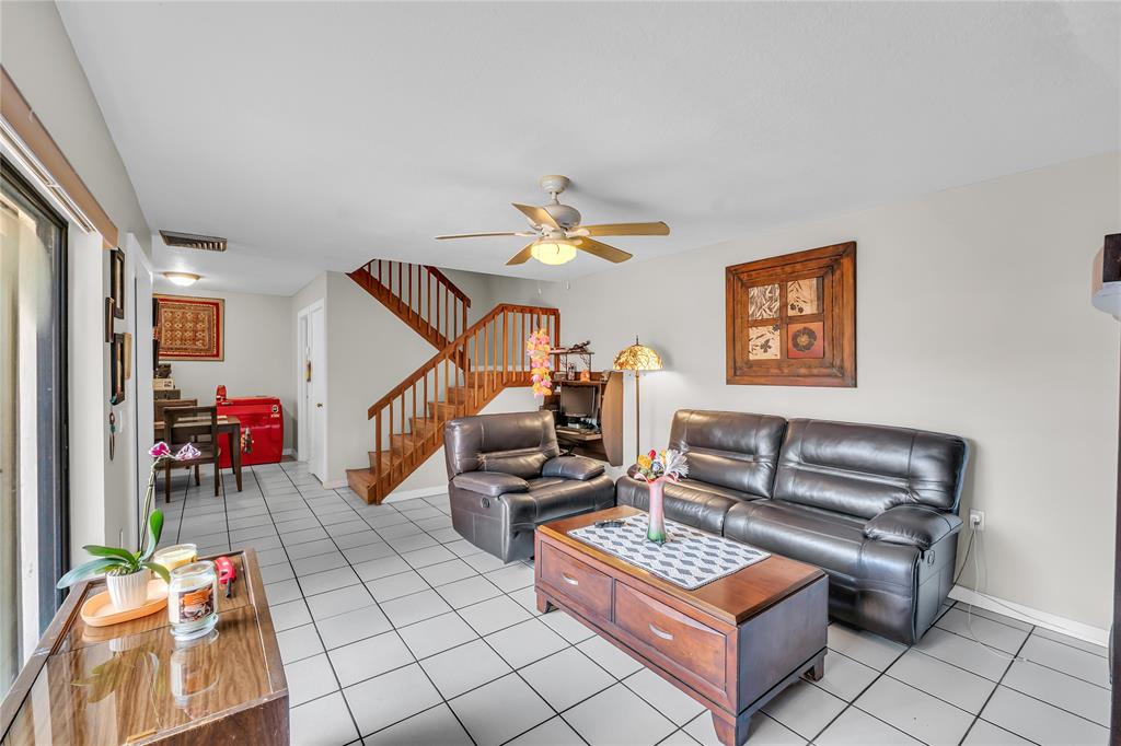 a living room with furniture and a potted plant