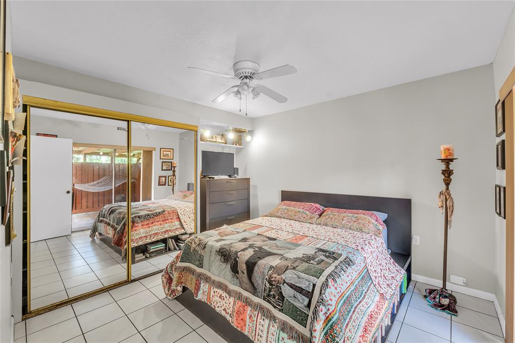 9104 Southwest 19th Place, Unit A Davie, FL 33324 - Photo 14 of 31 a bedroom with a bed and wooden floor