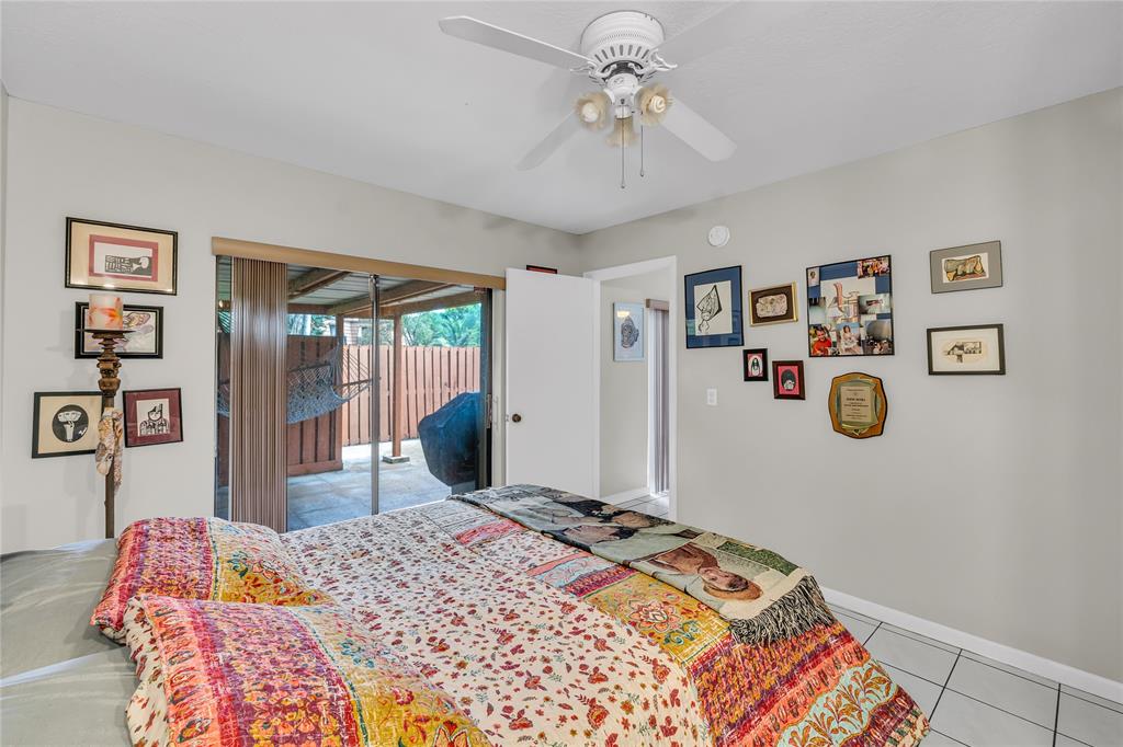 9104 Southwest 19th Place, Unit A Davie, FL 33324 - Photo 15 of 31 a bedroom with a bed and painting on the wall