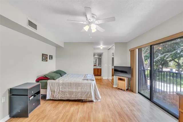 a bedroom with furniture and large window
