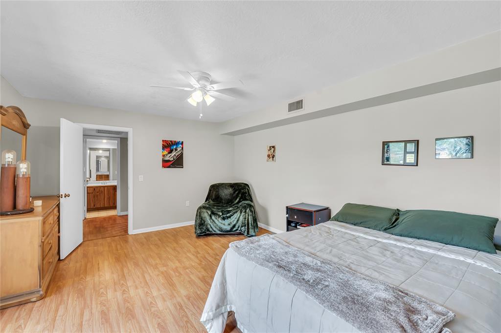 9104 Southwest 19th Place, Unit A Davie, FL 33324 - Photo 18 of 31 a bedroom with two beds and a chandelier