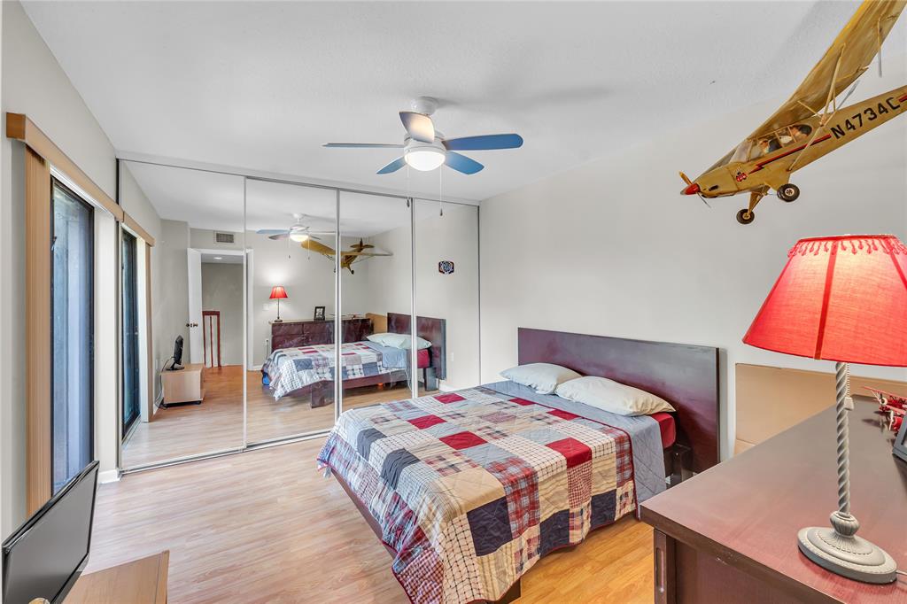 9104 Southwest 19th Place, Unit A Davie, FL 33324 - Photo 22 of 31 a bedroom with a bed and a chandelier