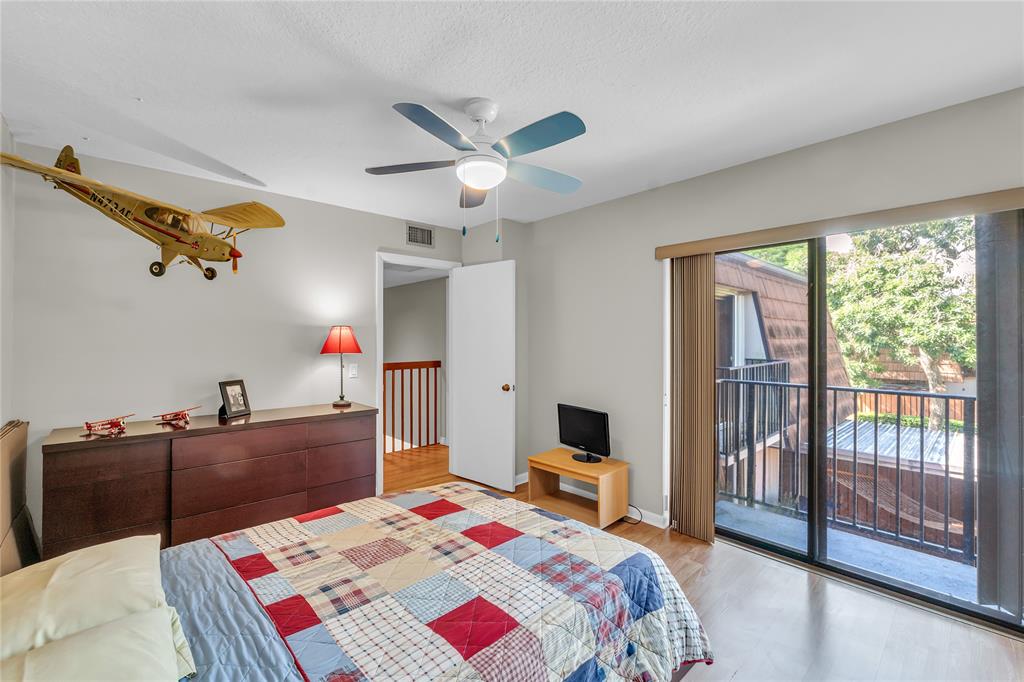 9104 Southwest 19th Place, Unit A Davie, FL 33324 - Photo 23 of 31 a bedroom that has a bed and a chandelier