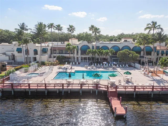 a view of swimming pool with outdoor seating and lake view