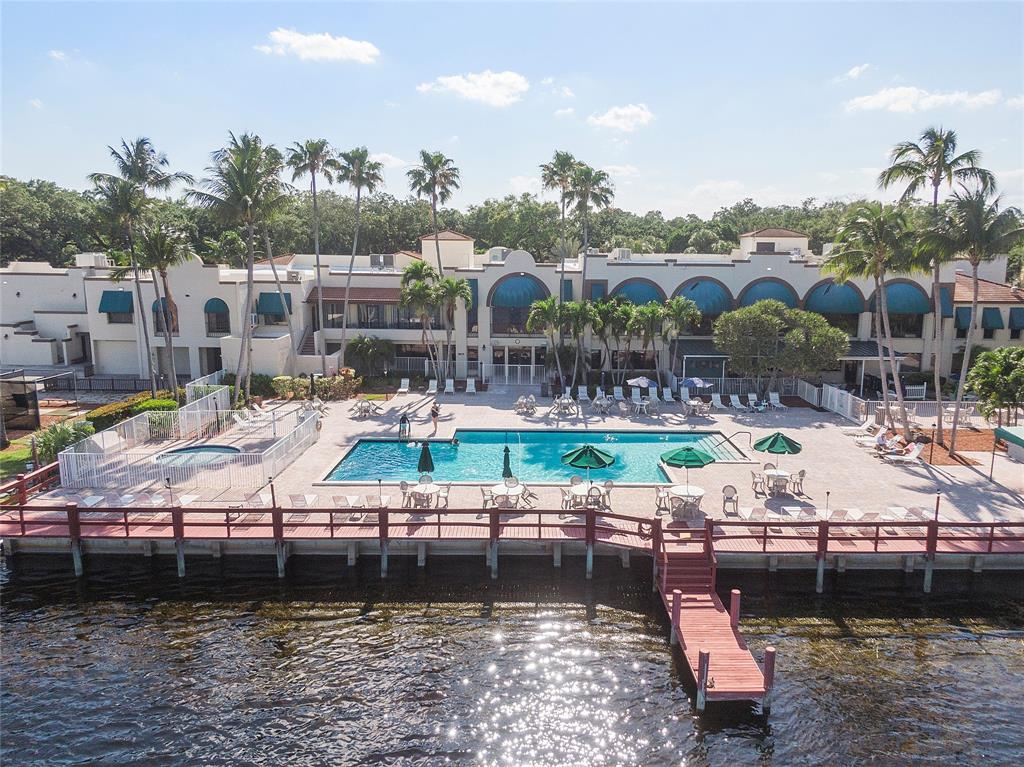 9104 Southwest 19th Place, Unit A Davie, FL 33324 - Photo 30 of 31 a view of swimming pool with outdoor seating and lake view