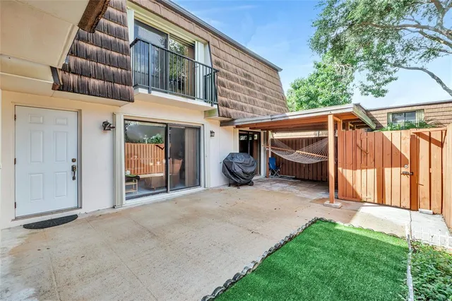 a view of a house with backyard and porch