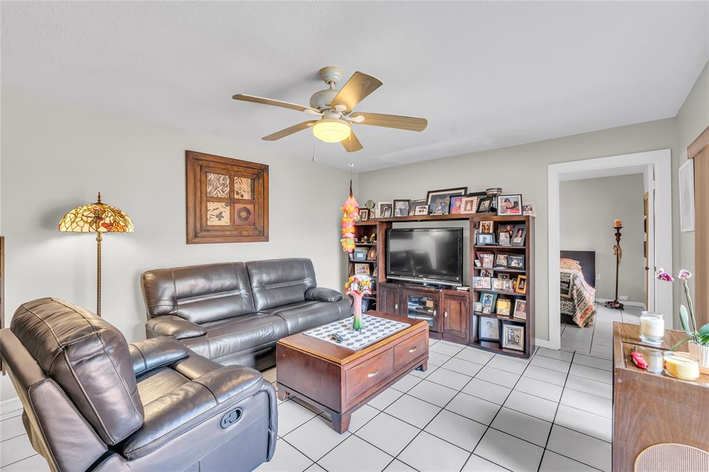 9104 Southwest 19th Place, Unit A Davie, FL 33324 - Photo 5 of 31 a living room with furniture and a flat screen tv