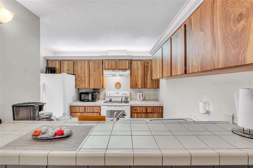 9104 Southwest 19th Place, Unit A Davie, FL 33324 - Photo 10 of 31 a kitchen with a refrigerator and a stove