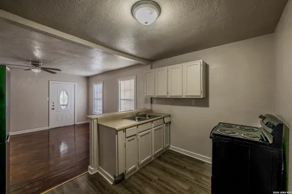 a kitchen with granite countertop a stove and a sink