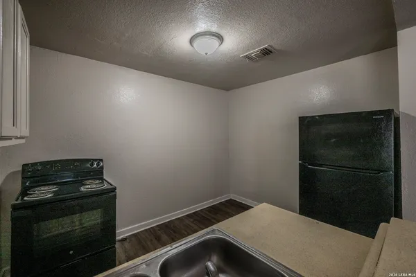 a kitchen with a refrigerator and cabinets