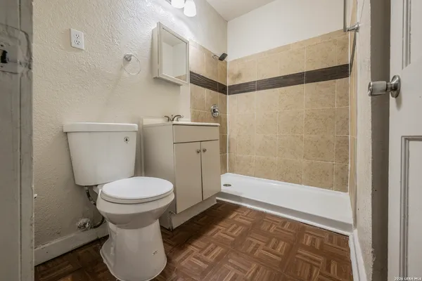 a bathroom with a toilet and a shower