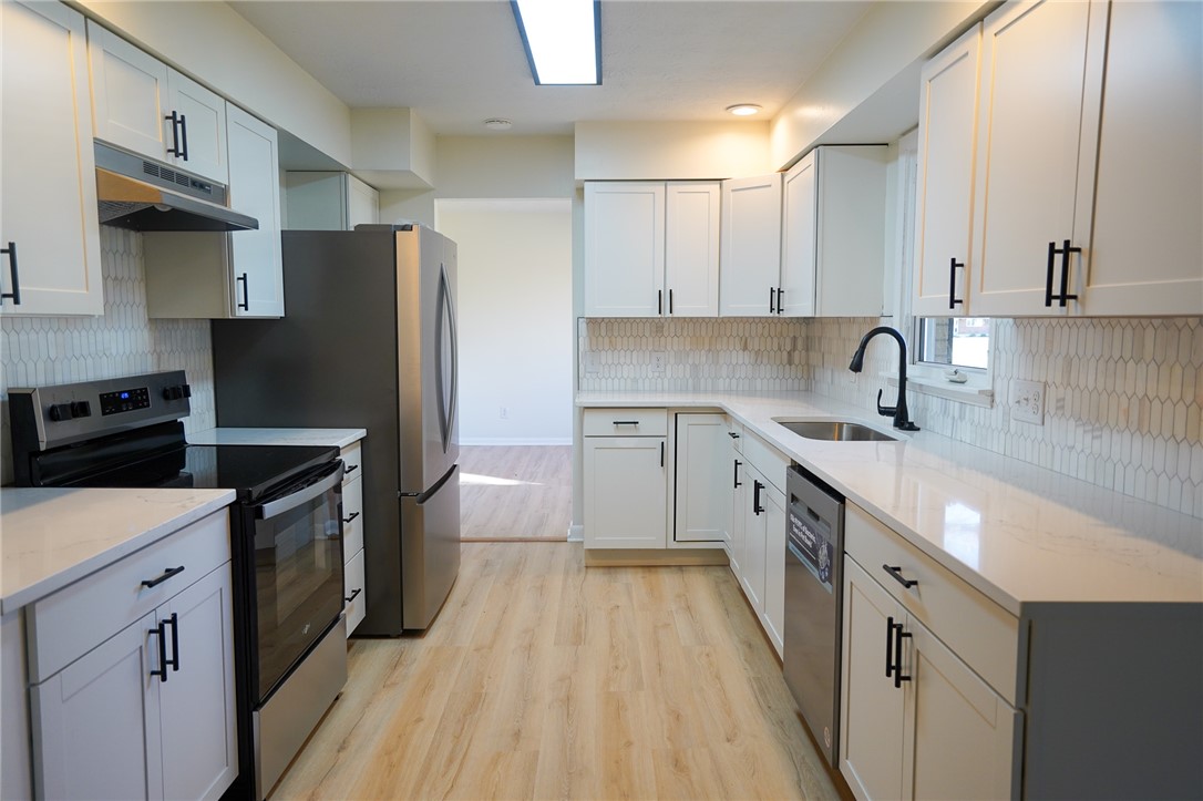 8746 Grubbs-Rex Road Arcanum, OH 45304 - Photo 35 of 38 This newly remodeled kitchen features sleek white cabinetry and modern stainless steel appliances.