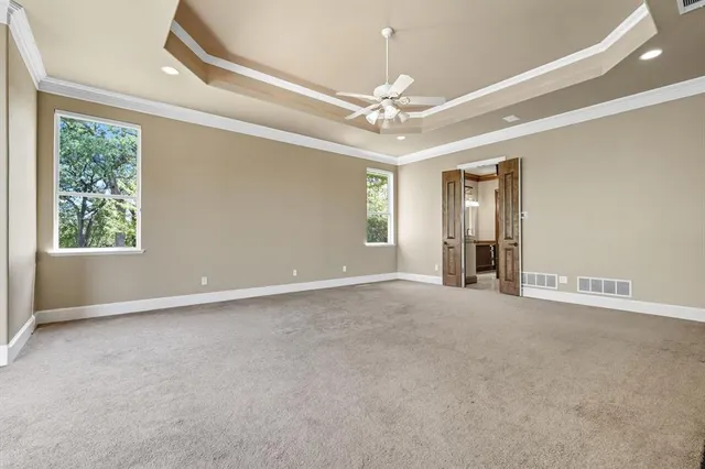 a view of an empty room with a fireplace and a window