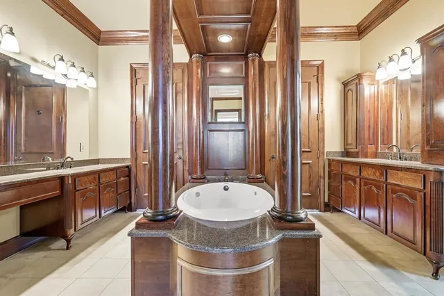 a bathroom with a granite countertop sink a mirror and a shower