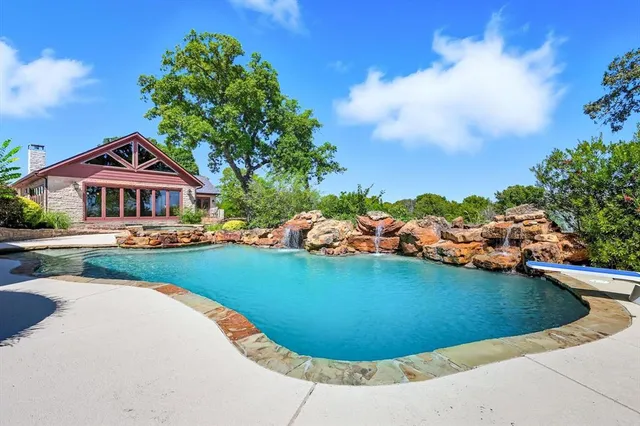 a view of swimming pool with outdoor seating and a yard