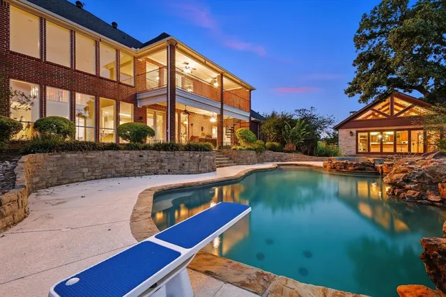 a view of a swimming pool with a patio and a garden
