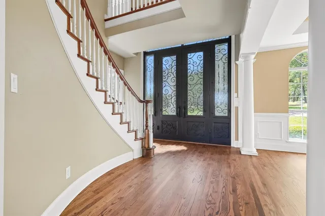 a view of entryway with wooden floor and stairs