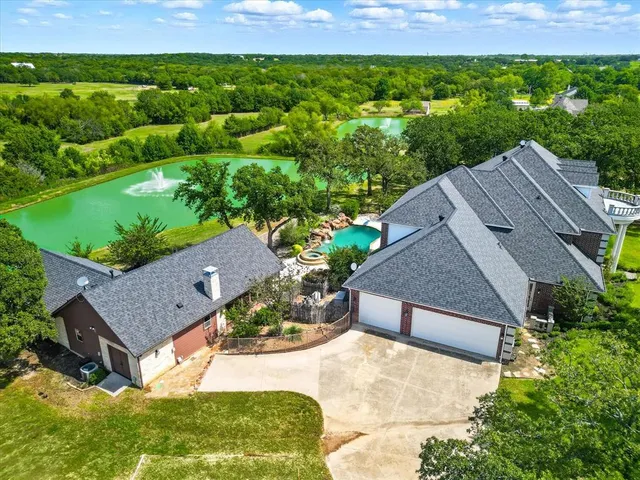 an aerial view of a residential houses with outdoor space and garden
